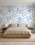 Pale Foliage Delft willow leaf wallpaper behind a low platform bed in a serene Japandi bedroom
