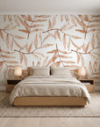 Pale Foliage Terracotta willow leaf wallpaper behind a low platform bed in a serene Japandi bedroom