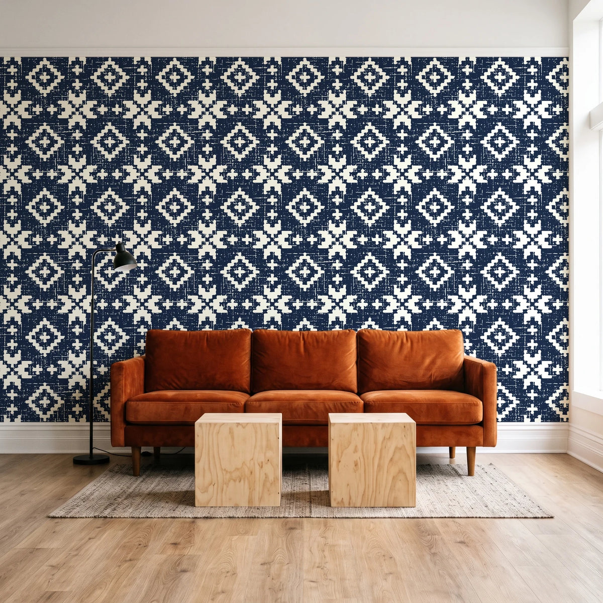 Pale Kilim Midnight kilim wallpaper behind a rust velvet sofa in a bright coworking lounge