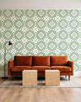 Pale Kilim Sage kilim wallpaper behind a rust velvet sofa in a bright coworking lounge