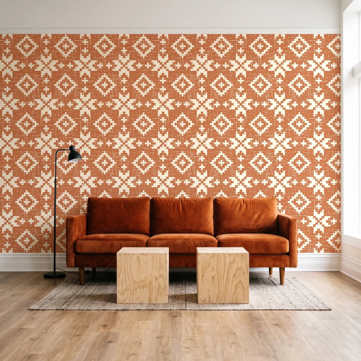 Pale Kilim Terracotta kilim wallpaper behind a rust velvet sofa in a bright coworking lounge