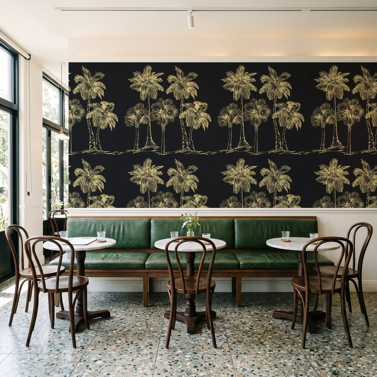 Palm Shade Onyx palm grove wallpaper above a green leather banquette in a sunlit neighborhood cafe