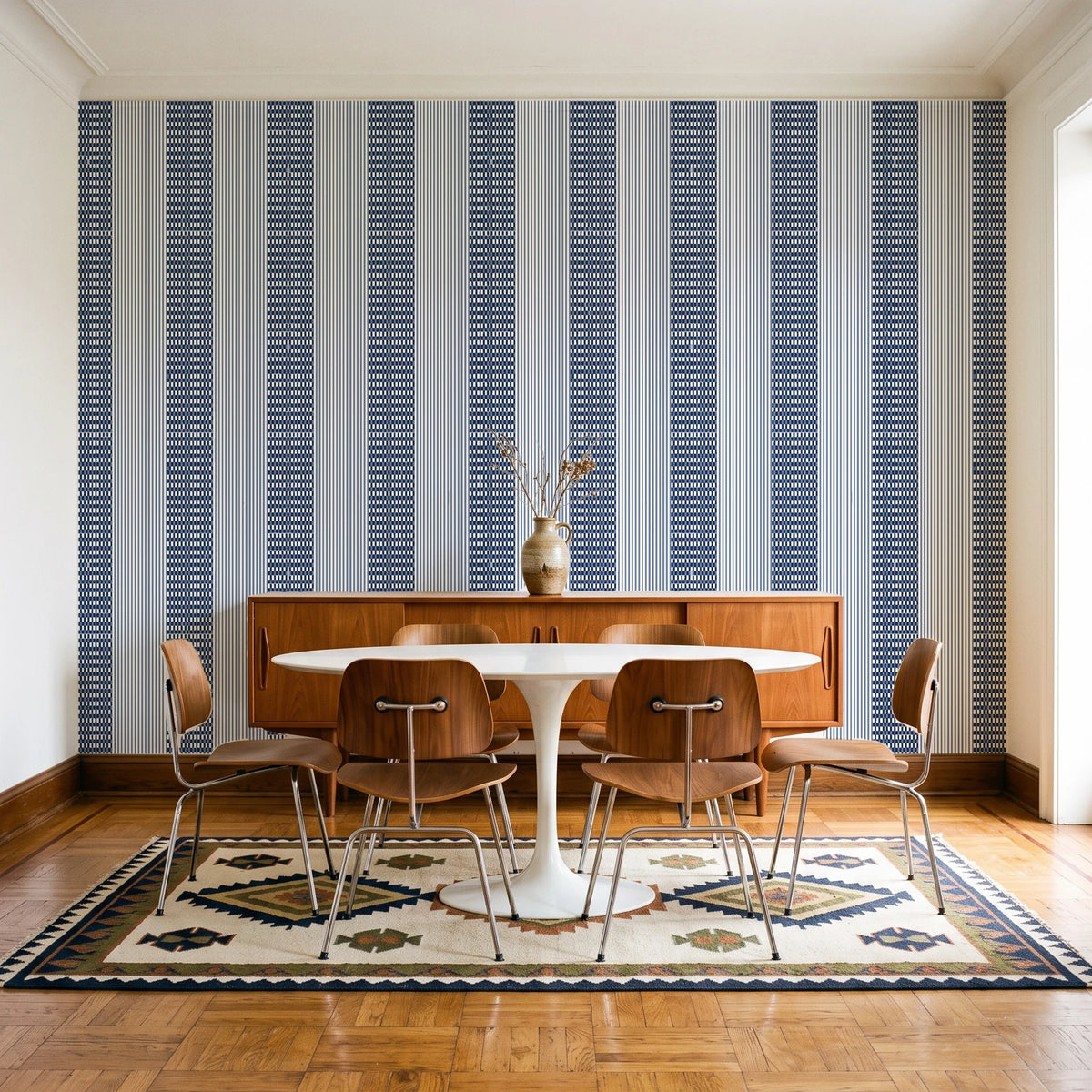 Parlor Stripe Midnight geometric stripe wallpaper in a mid-century dining room with a teak sideboard and tulip table