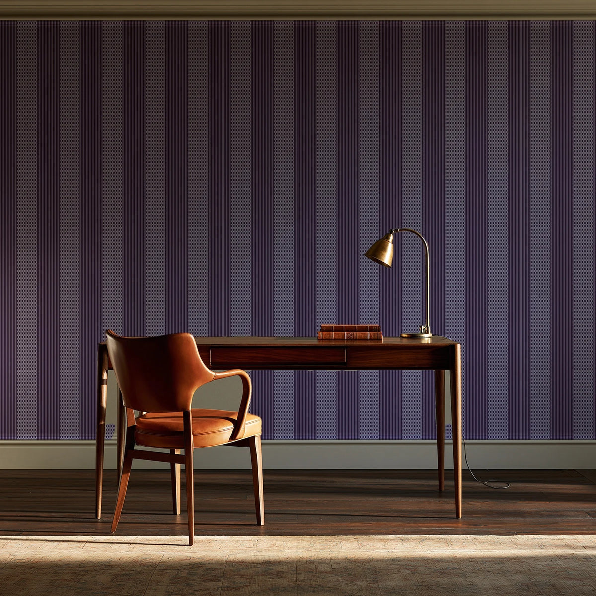 Parlor Stripe Plum geometric stripe wallpaper as a feature wall in a home study