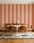 Parlor Stripe Terracotta geometric stripe wallpaper in a mid-century dining room with a teak sideboard and tulip table
