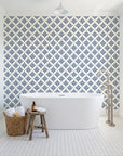 Pastel Bouquet Parade Navy botanical damask wallpaper behind a freestanding tub in a bright coastal bathroom