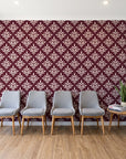 Pastel Bouquet Parade Oxblood botanical damask wallpaper behind a row of upholstered chairs in a bright clinic waiting room