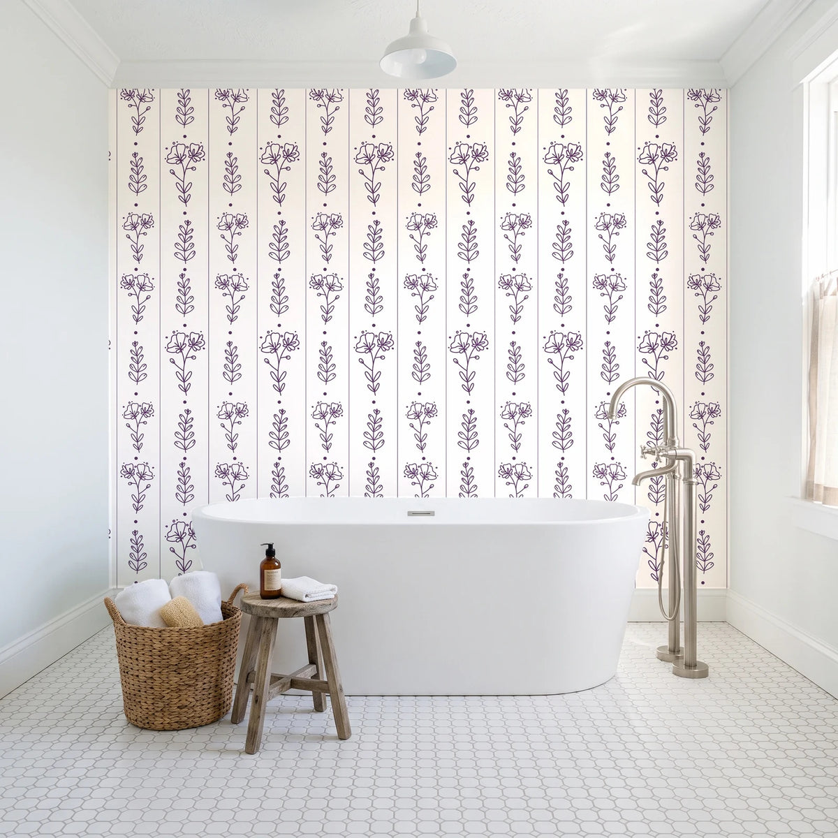Petal & Thread Plum botanical stem wallpaper behind a freestanding tub in a bright coastal bathroom