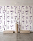 Petal & Thread Plum botanical stem wallpaper behind a travertine pedestal and vase in a minimal boutique