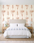 Petal & Thread Terracotta botanical stem wallpaper behind a queen bed in a bright coastal bedroom