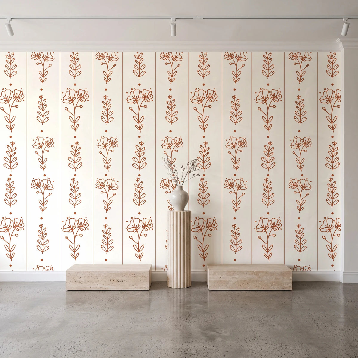 Petal & Thread Terracotta botanical stem wallpaper behind a travertine pedestal and vase in a minimal boutique