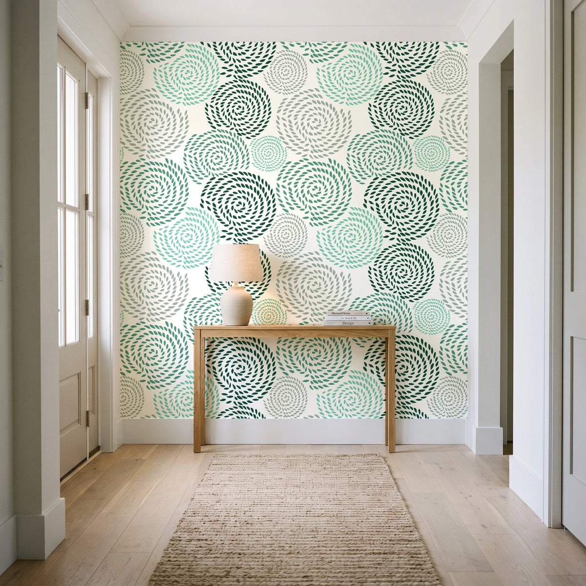 Petal Cascade Emerald spiral rosette wallpaper behind a console table in a light entry hallway