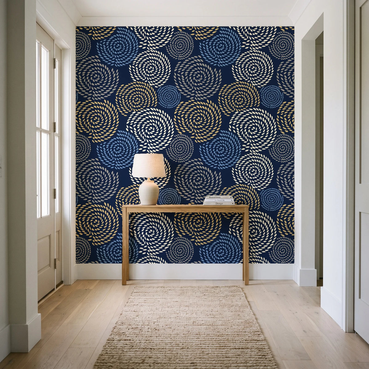 Petal Cascade Midnight spiral rosette wallpaper behind a console table in a light entry hallway