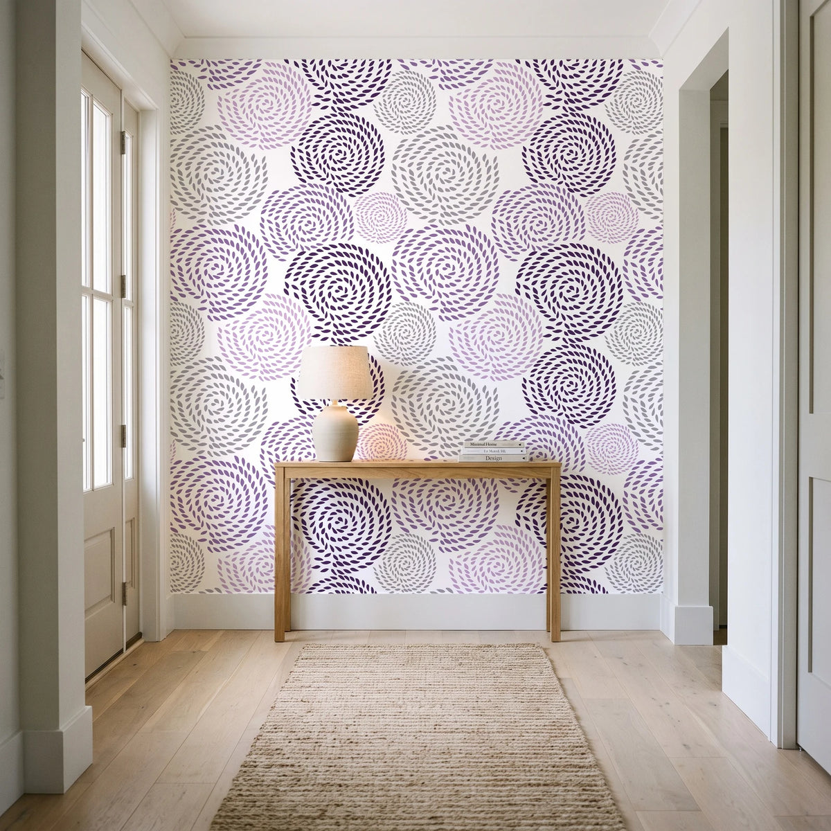 Petal Cascade Plum spiral rosette wallpaper behind a console table in a light entry hallway