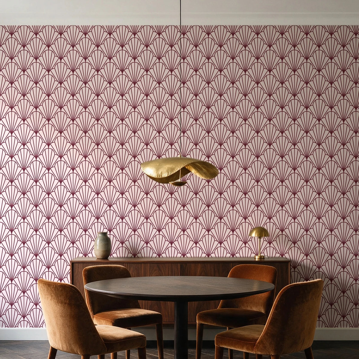 Petal Dawn Oxblood art deco fan wallpaper behind a walnut credenza and round table in an elegant dining room