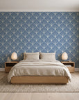 Petal Dawn Slate art deco fan wallpaper behind a low platform bed in a serene Japandi bedroom