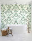 Petal Reflection Sage floral damask wallpaper behind a freestanding tub in a bright coastal bathroom