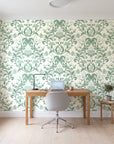 Petal Reflection Sage floral damask wallpaper behind a modern oak desk in a bright home office
