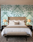Petal Reflection Sage floral damask wallpaper behind the headboard of a king bed in a contemporary hotel guest room