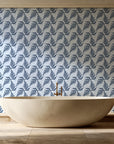 Pewter Fern Navy fern wallpaper creating ambiance in a serene spa bathroom