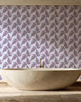 Pewter Fern Plum fern wallpaper creating ambiance in a serene spa bathroom
