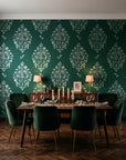Porcelain Bouquet Emerald damask wallpaper in a dark moody dining room with a candlelit table