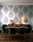 Porcelain Bouquet Inkwell damask wallpaper in a dark moody dining room with a candlelit table