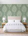Porcelain Bouquet Sage damask wallpaper behind a queen bed in a bright coastal bedroom