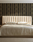 Porcelain Filigree Noir filigree damask wallpaper behind a channel-tufted bed in a calm primary bedroom