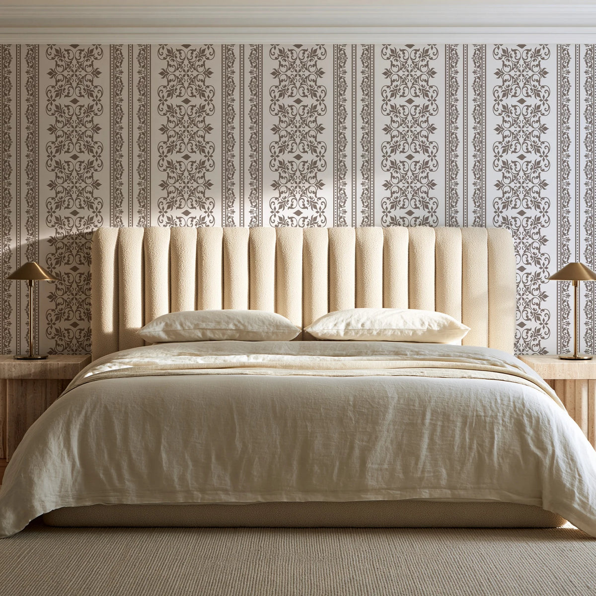 Porcelain Filigree Taupe filigree damask wallpaper behind a channel-tufted bed in a calm primary bedroom