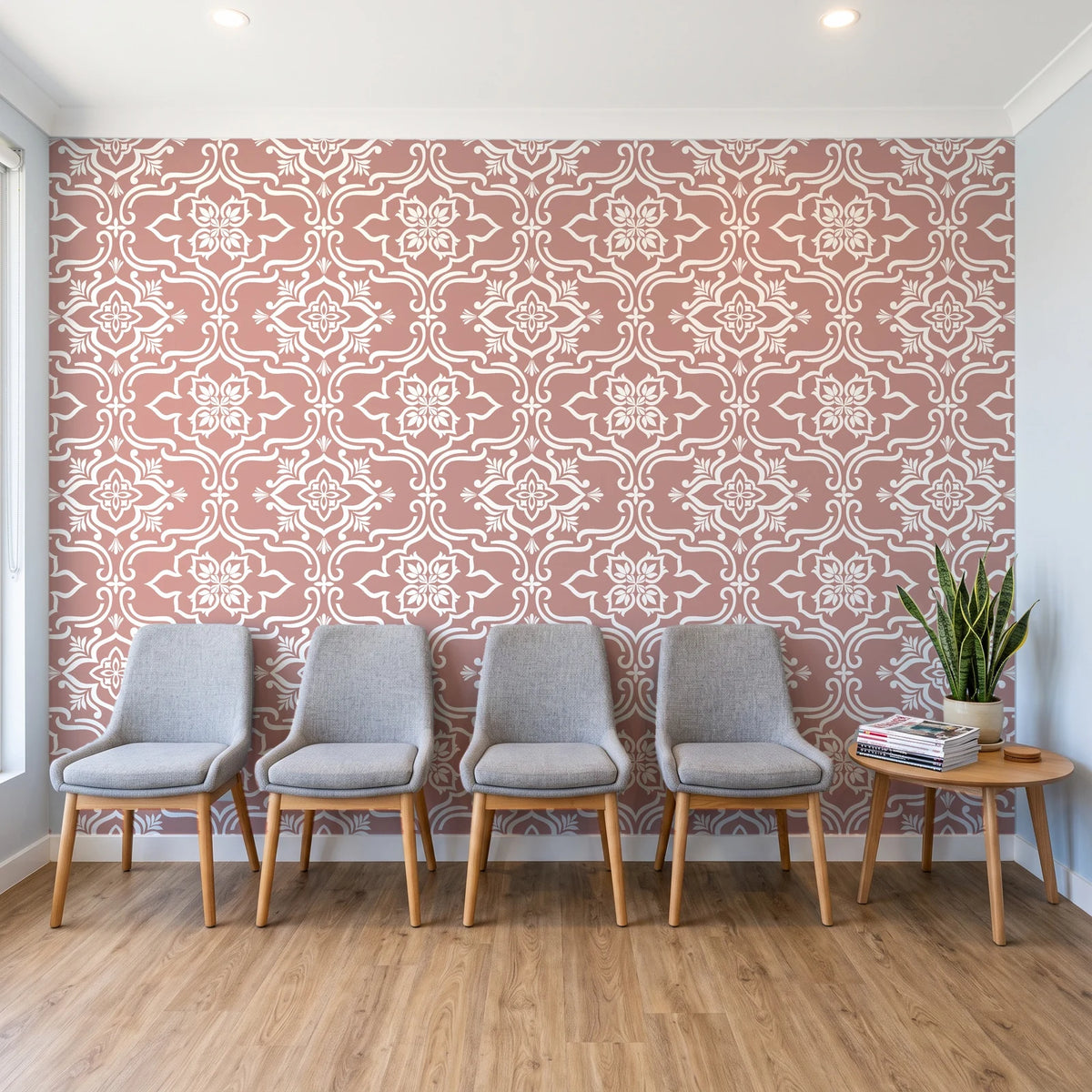 Pure Fern Fantasy Dusty Rose fern medallion wallpaper behind a row of upholstered chairs in a bright clinic waiting room