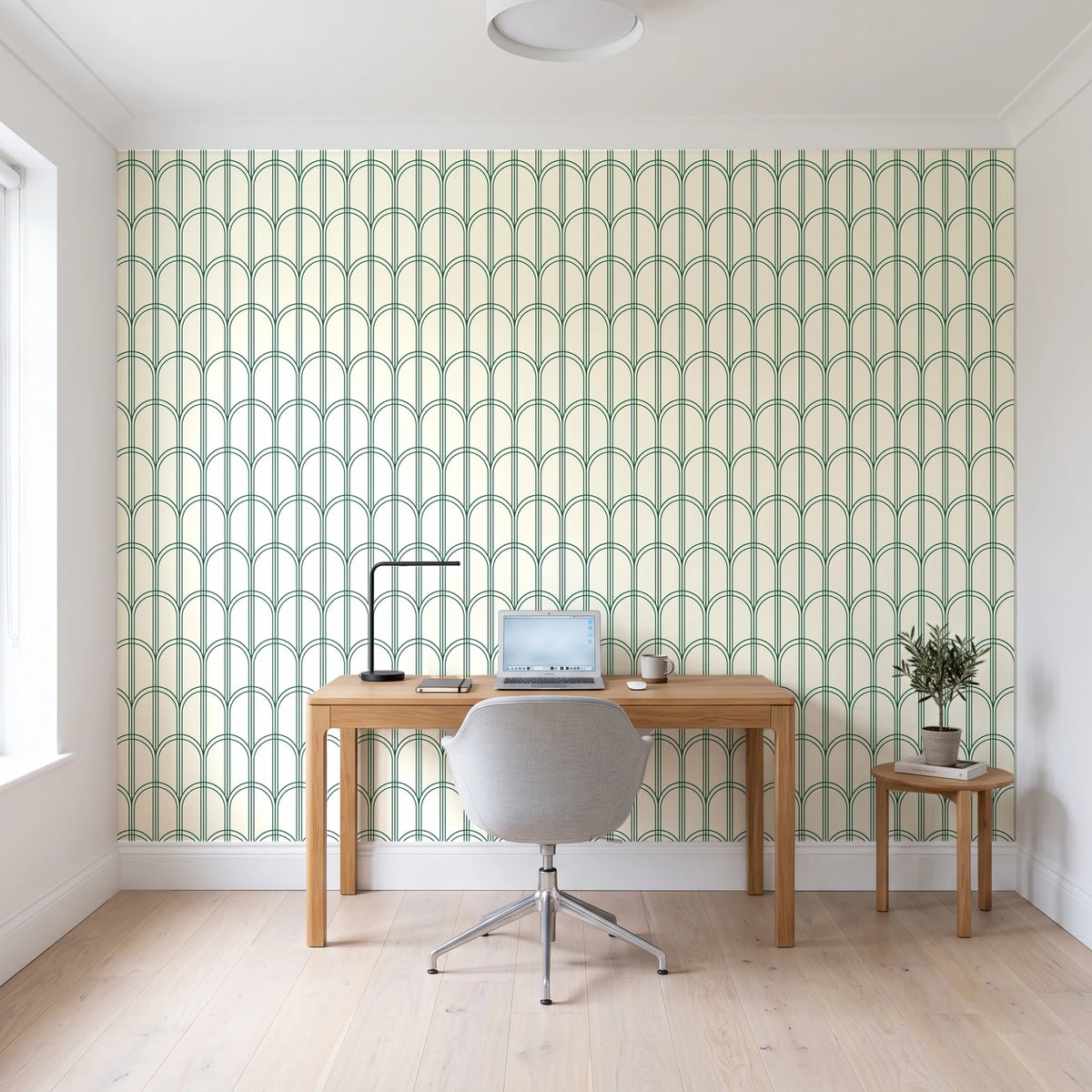 Quiet Grace Emerald minimalist arch wallpaper behind a modern oak desk in a bright home office