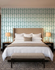 Quiet Grace Emerald minimalist arch wallpaper behind the headboard of a king bed in a contemporary hotel guest room