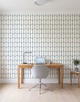 Quiet Grace Midnight minimalist arch wallpaper behind a modern oak desk in a bright home office