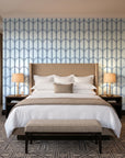 Quiet Grace Midnight minimalist arch wallpaper behind the headboard of a king bed in a contemporary hotel guest room