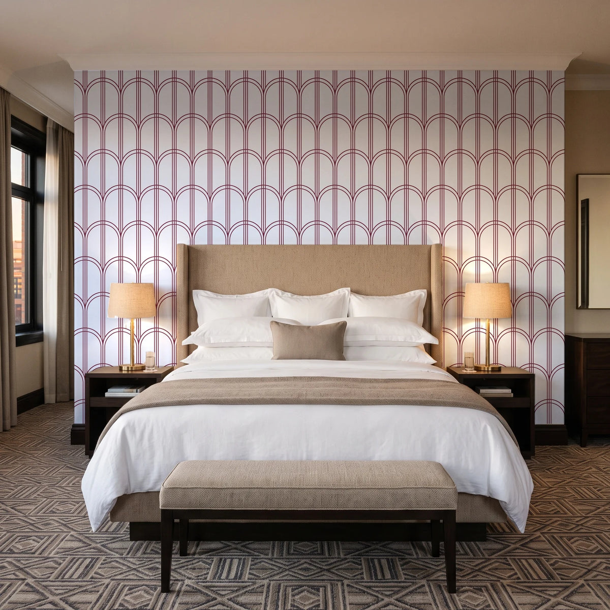 Quiet Grace Oxblood minimalist arch wallpaper behind the headboard of a king bed in a contemporary hotel guest room