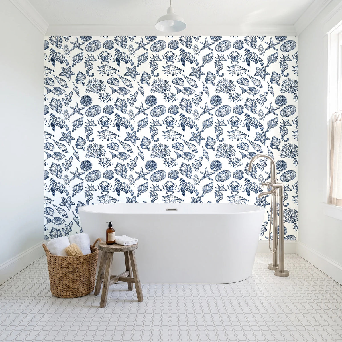 Quiet Reef Navy sea life wallpaper behind a freestanding tub in a bright coastal bathroom