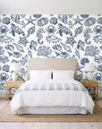 Quiet Reef Navy sea life wallpaper behind a queen bed in a bright coastal bedroom