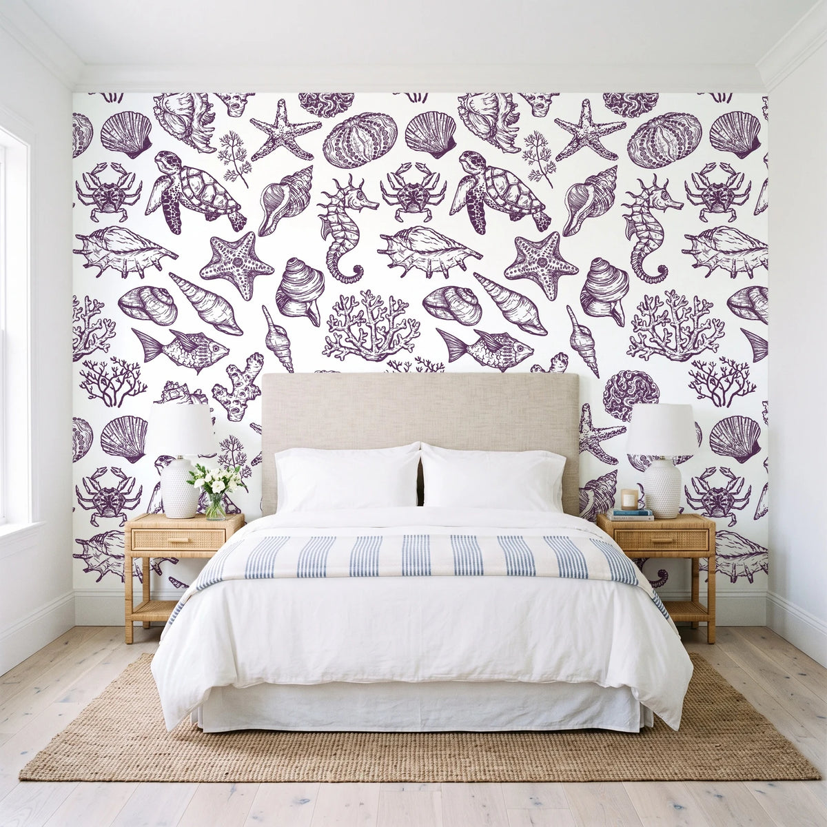 Quiet Reef Plum sea life wallpaper behind a queen bed in a bright coastal bedroom
