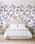 Quiet Reef Plum sea life wallpaper behind a queen bed in a bright coastal bedroom
