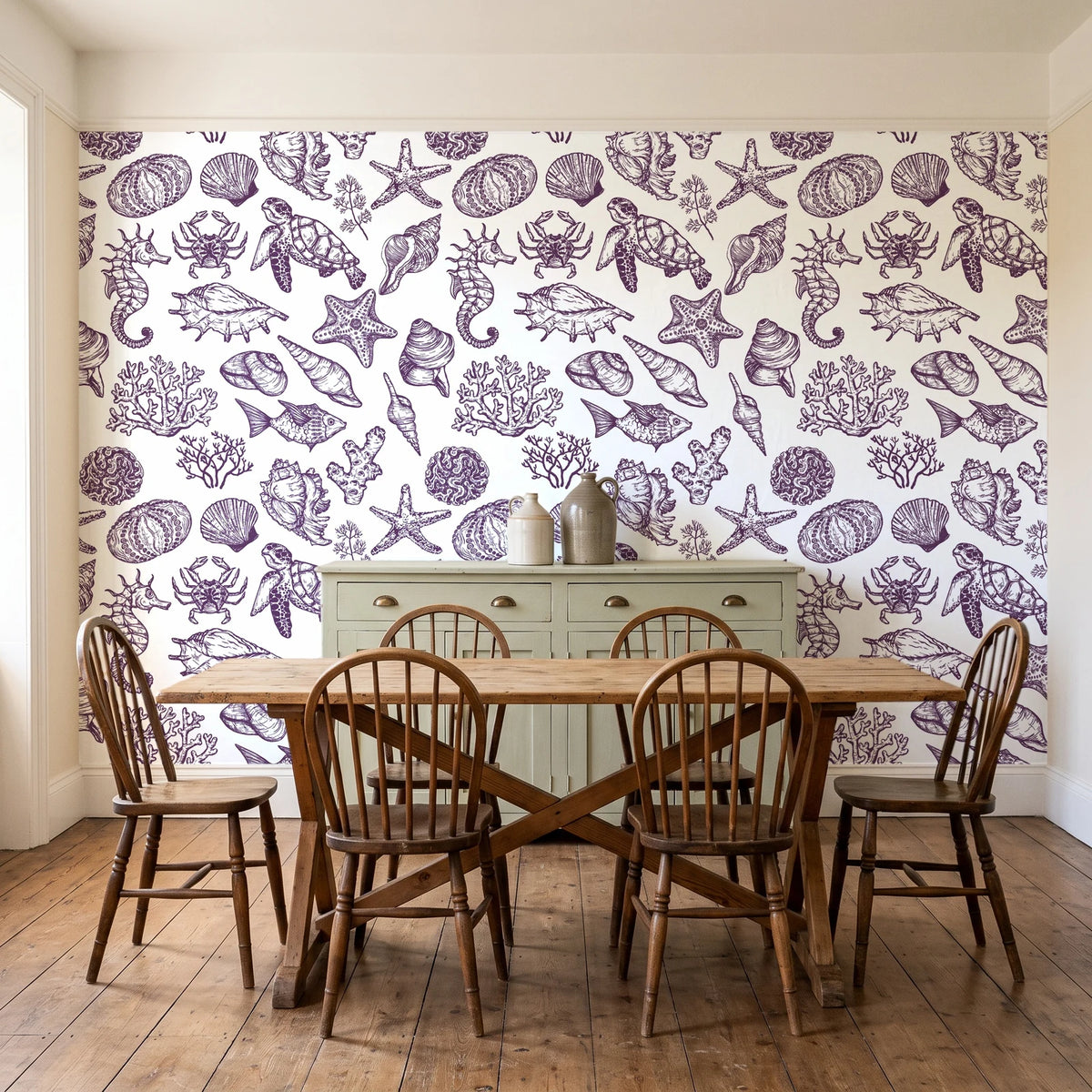 Quiet Reef Plum sea life wallpaper in a farmhouse dining room with a sage sideboard and rustic trestle table