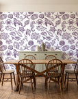 Quiet Reef Plum sea life wallpaper in a farmhouse dining room with a sage sideboard and rustic trestle table
