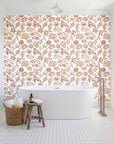 Quiet Reef Terracotta sea life wallpaper behind a freestanding tub in a bright coastal bathroom
