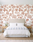 Quiet Reef Terracotta sea life wallpaper behind a queen bed in a bright coastal bedroom