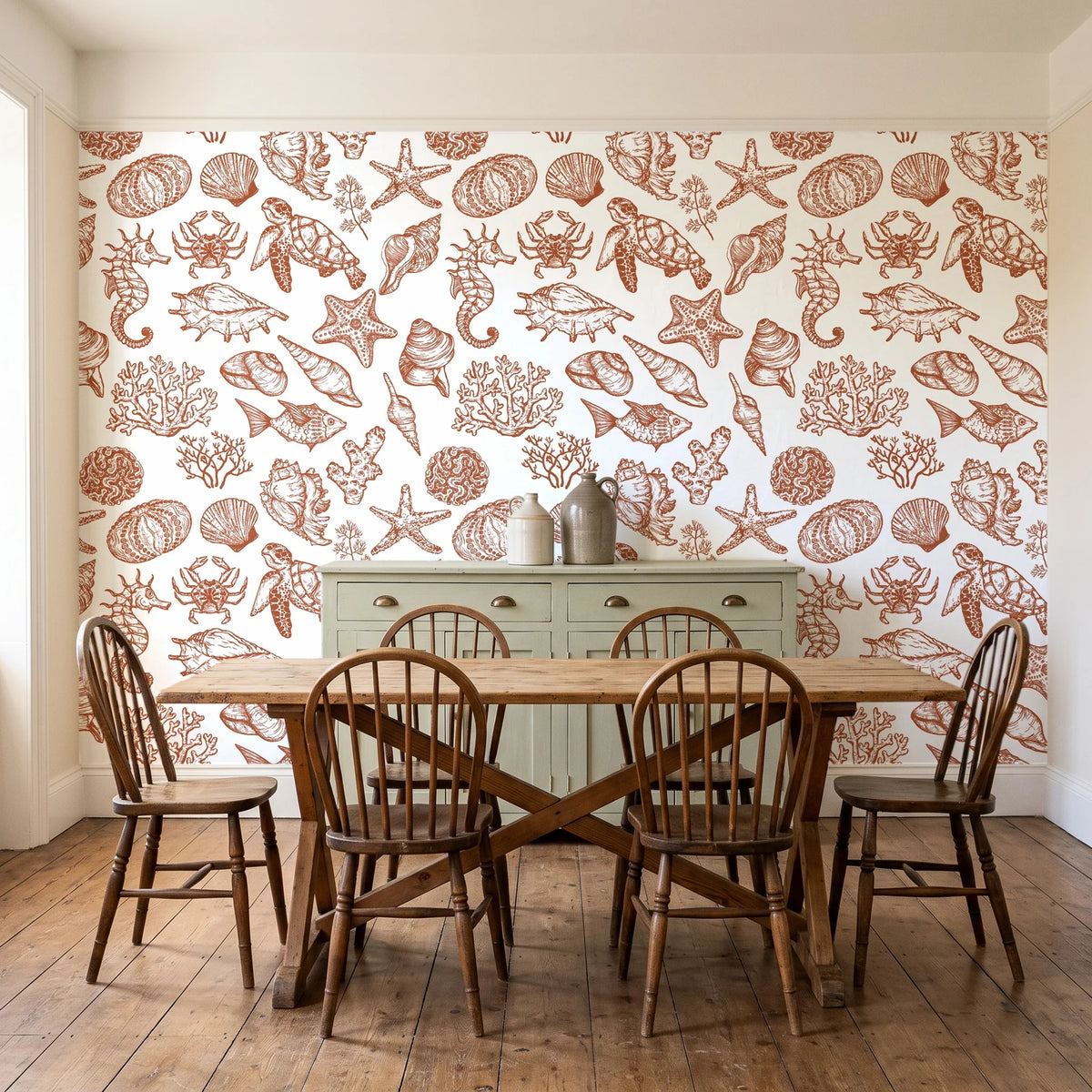 Quiet Reef Terracotta sea life wallpaper in a farmhouse dining room with a sage sideboard and rustic trestle table