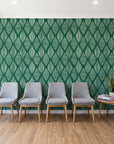 Reed & Smoke Emerald geometric wallpaper behind a row of upholstered chairs in a bright clinic waiting room