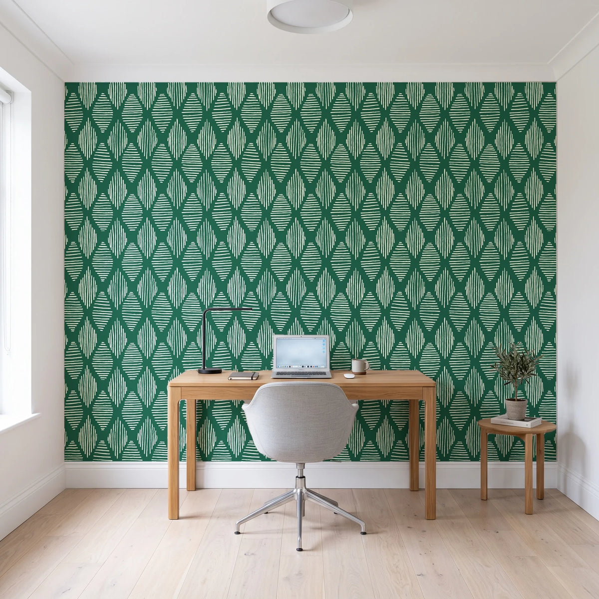 Reed & Smoke Emerald geometric wallpaper behind a modern oak desk in a bright home office