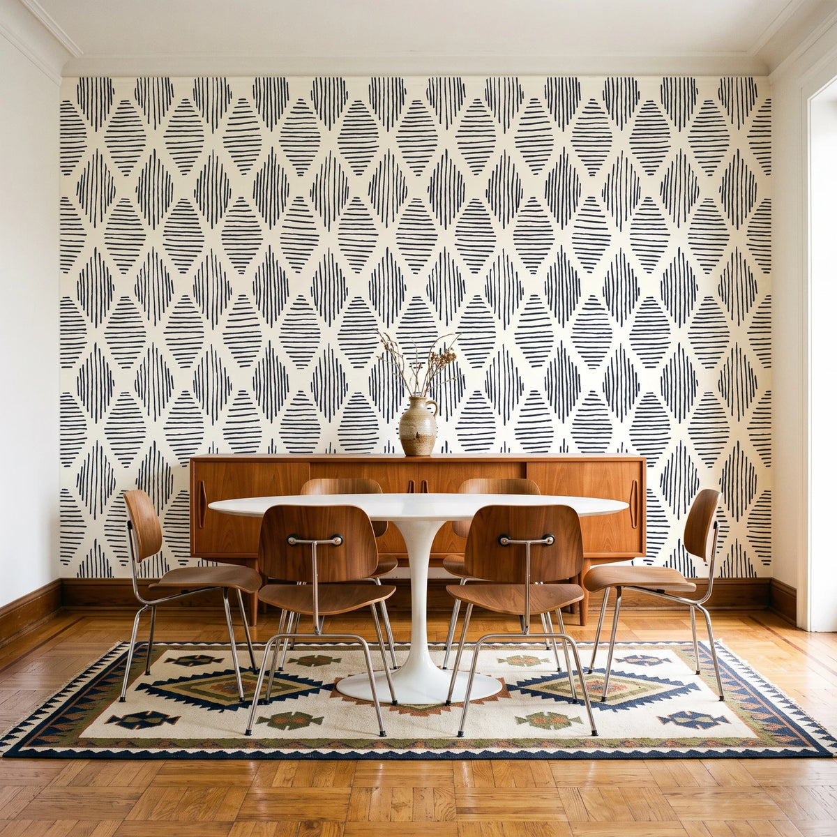 Reed & Smoke Ink geometric wallpaper in a mid-century dining room with a teak sideboard and tulip table