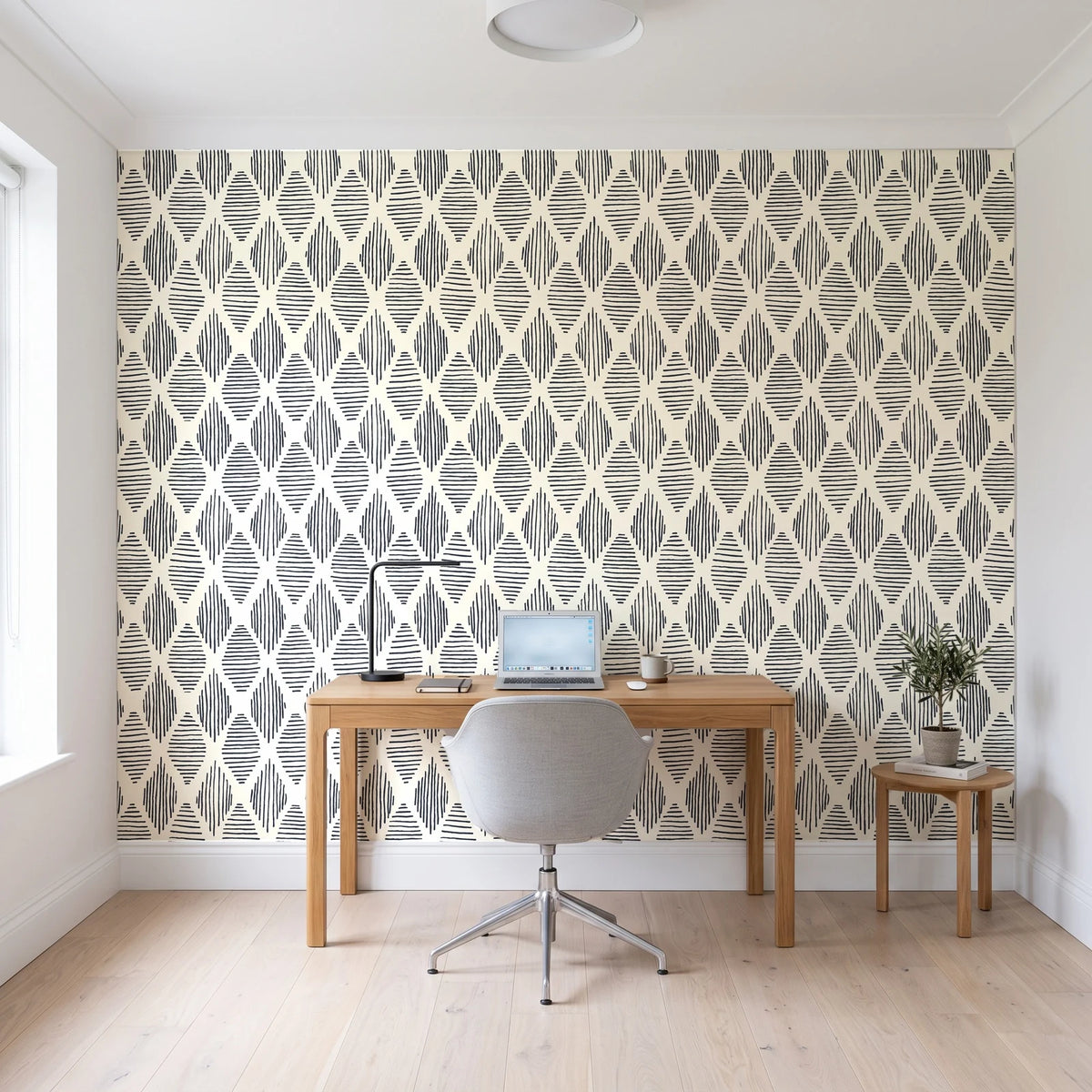 Reed & Smoke Ink geometric wallpaper behind a modern oak desk in a bright home office