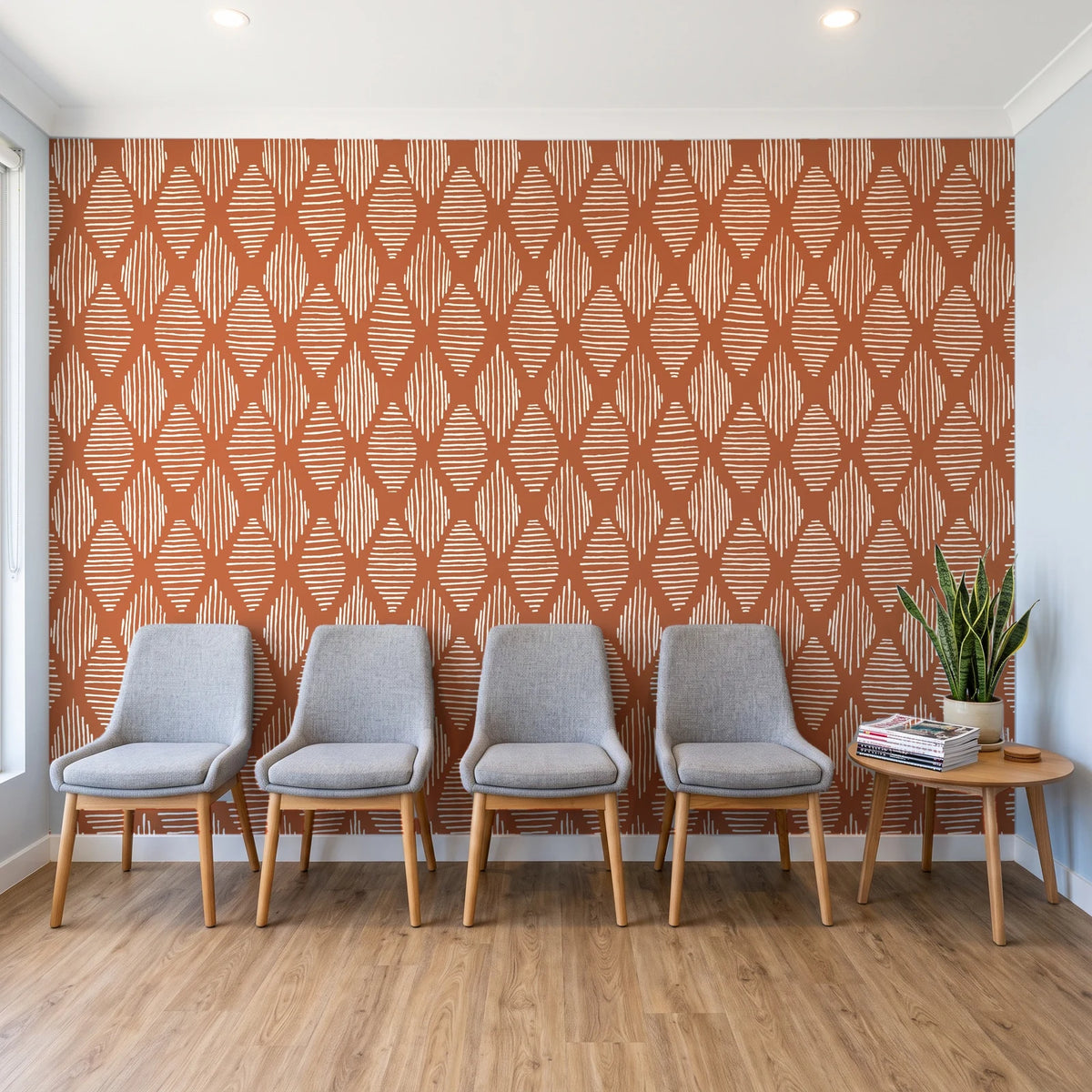 Reed & Smoke Terracotta geometric wallpaper behind a row of upholstered chairs in a bright clinic waiting room